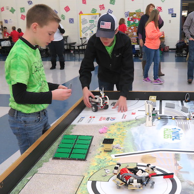 FLL students working together in a competition